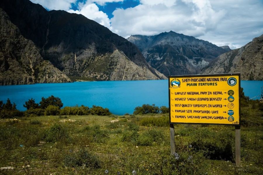 Turquoise Phoksundo Lake with Shey Phoksundo National Park information sign